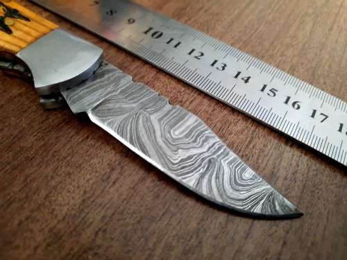 Handmade Damascus steel folding knife with wooden handle scales. Dog picture engraved. NEW STOCK !
