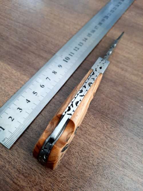 Handmade Damascus steel folding knife with wooden handle scales. Dog picture engraved. NEW STOCK !