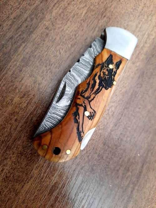 Handmade Damascus steel folding knife with wooden handle scales. Dog picture engraved. NEW STOCK !