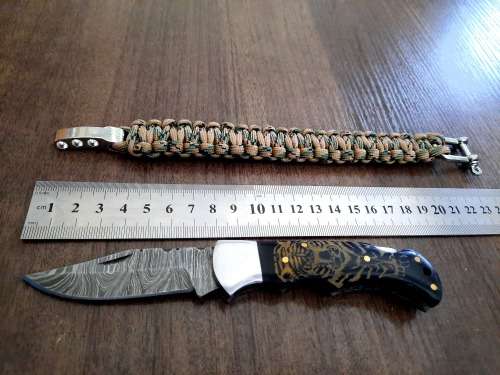 Handmade Damascus steel folding knife with Bull Horn handle scales. FREE SURVIVAL to the winner.