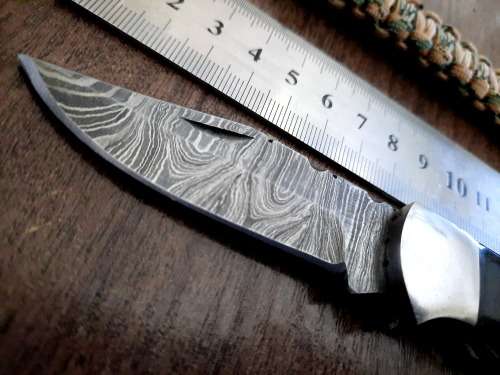 Handmade Damascus steel folding knife with Bull Horn handle scales. FREE SURVIVAL to the winner.