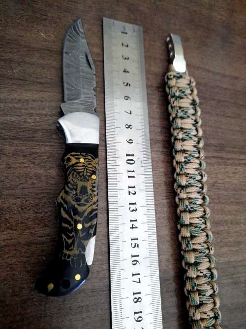 Handmade Damascus steel folding knife with Bull Horn handle scales. FREE SURVIVAL to the winner.