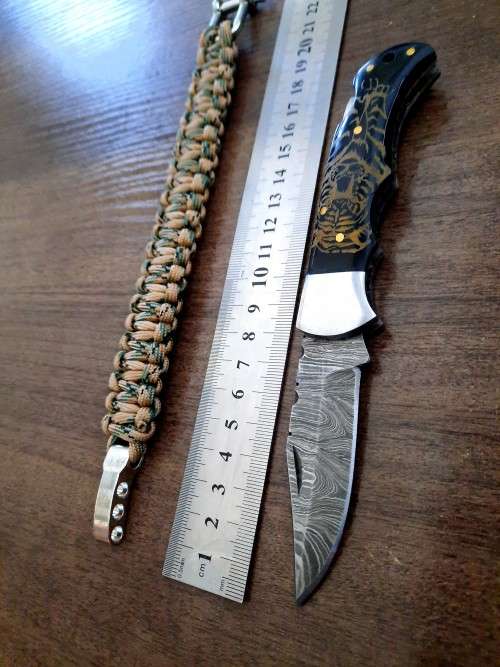 Handmade Damascus steel folding knife with Bull Horn handle scales. FREE SURVIVAL to the winner.