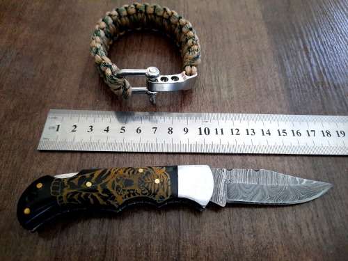 Handmade Damascus steel folding knife with Bull Horn handle scales. FREE SURVIVAL to the winner.