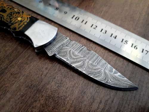 Handmade Damascus steel folding knife with Bull Horn handle scales. FREE SURVIVAL to the winner.