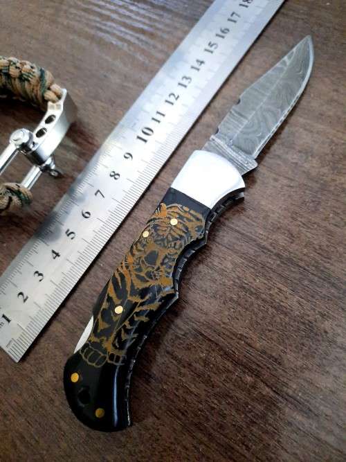 Handmade Damascus steel folding knife with Bull Horn handle scales. FREE SURVIVAL to the winner.