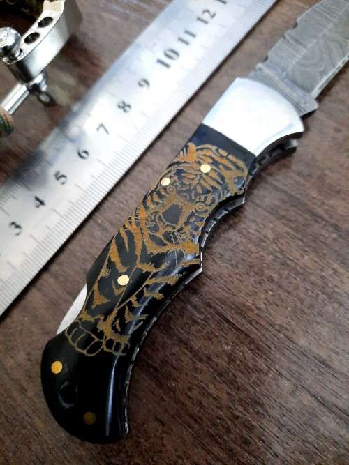 Handmade Damascus steel folding knife with Bull Horn handle scales. FREE SURVIVAL to the winner.