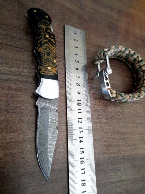 Handmade Damascus steel folding knife with Bull Horn handle scales. FREE SURVIVAL to the winner.