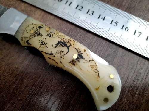 Handmade Damascus steel folding knife w Camel Bone Handle Scales. Art engraved.