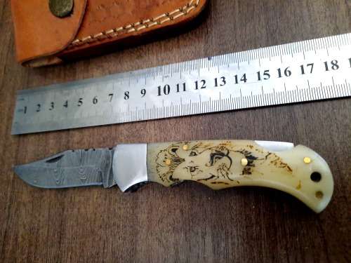 Handmade Damascus steel folding knife w Camel Bone Handle Scales. Art engraved.