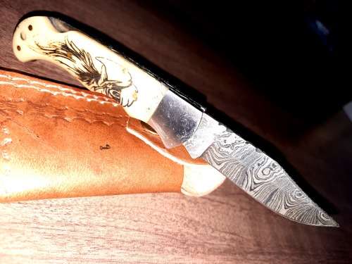 Handmade Damascus steel folding knife w Camel Bone Handle Scales. Art engraved.