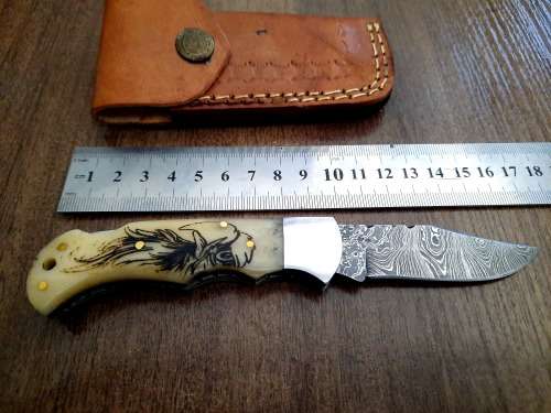 Handmade Damascus steel folding knife w Camel Bone Handle Scales. Art engraved.