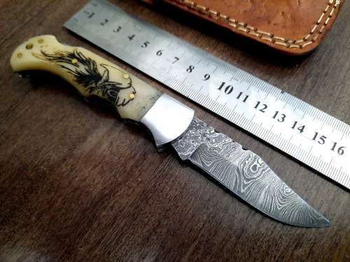 Handmade Damascus steel folding knife w Camel Bone Handle Scales. Art engraved.