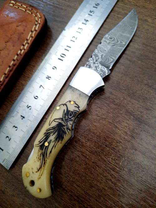 Handmade Damascus steel folding knife w Camel Bone Handle Scales. Art engraved.