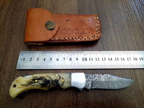 Handmade Damascus steel folding knife w Camel Bone Handle Scales. Art engraved.