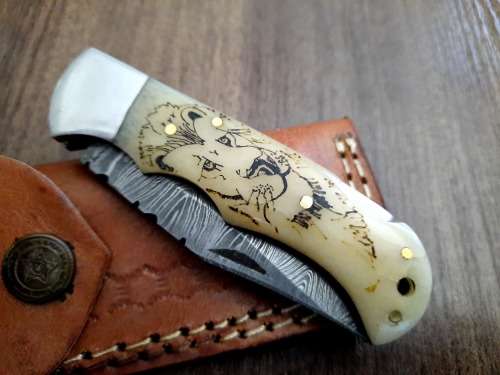 Handmade Damascus steel folding knife w Camel Bone Handle Scales. Art engraved.