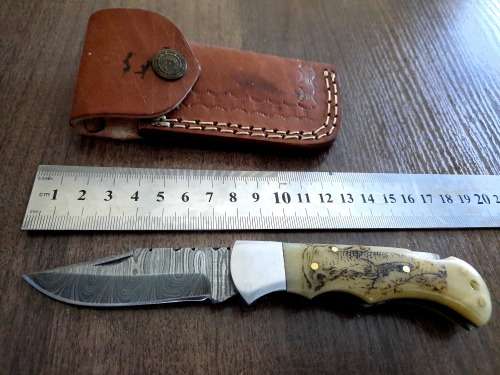 Handmade Damascus steel folding knife w Camel Bone Handle Scales. Art engraved.