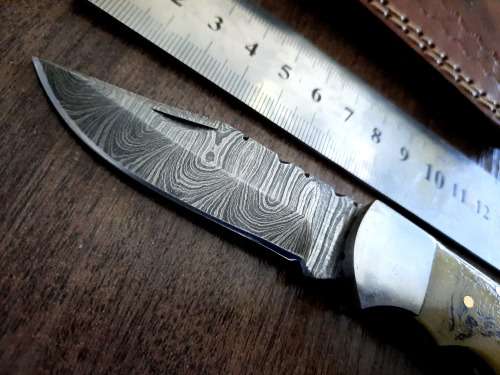 Handmade Damascus steel folding knife w Camel Bone Handle Scales. Art engraved.