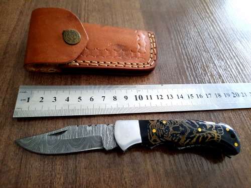 Handmade Damascus steel folding knife with Bull Horn Handle. Tiger picture engraved.