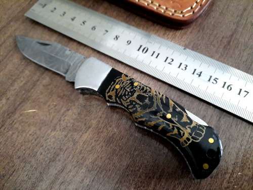 Handmade Damascus steel folding knife with Bull Horn Handle. Tiger picture engraved.