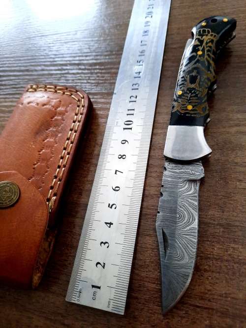 Handmade Damascus steel folding knife with Bull Horn Handle. Tiger picture engraved.