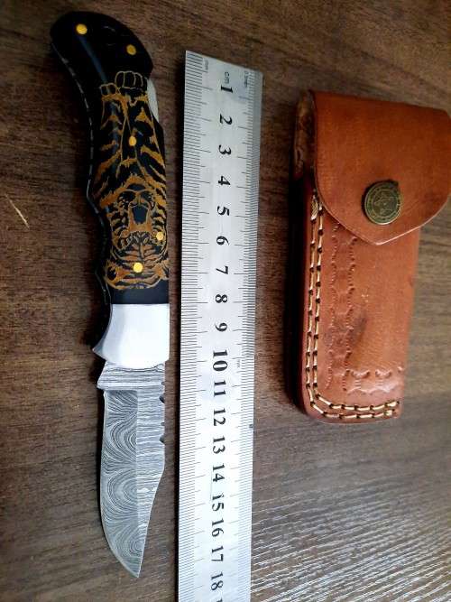 Handmade Damascus steel folding knife with Bull Horn Handle. Tiger picture engraved.