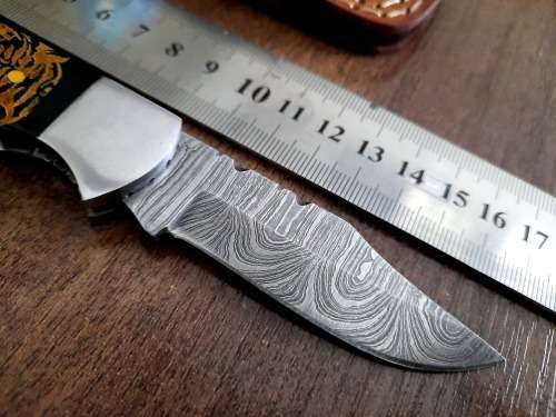 Handmade Damascus steel folding knife with Bull Horn Handle. Tiger picture engraved.