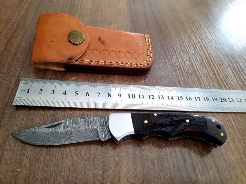 Handmade Damascus steel folding knife with wooden handle scales. Picture engraved. NEW STOCK !