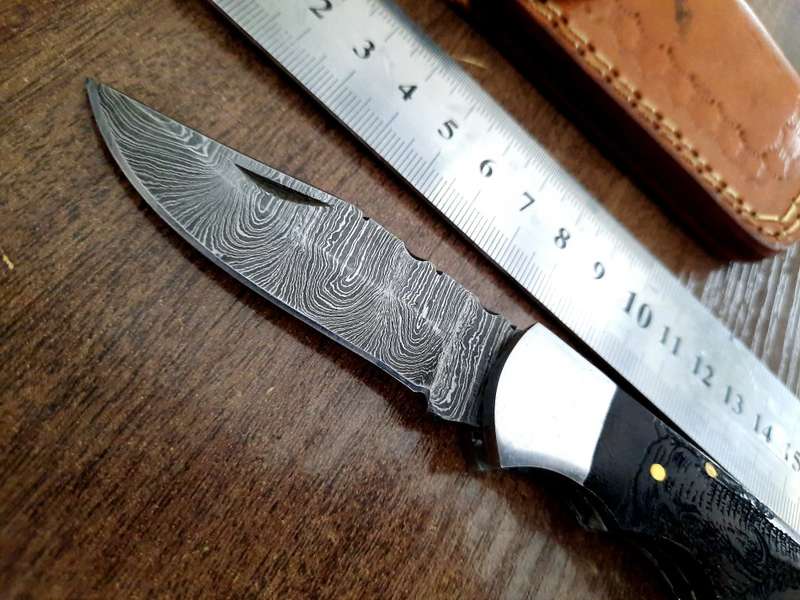 Handmade Damascus steel folding knife with wooden handle scales. Picture engraved. NEW STOCK !