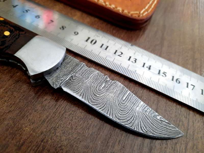 Handmade Damascus steel folding knife with wooden handle scales. Picture engraved. NEW STOCK !