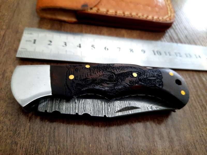 Handmade Damascus steel folding knife with wooden handle scales. Picture engraved. NEW STOCK !