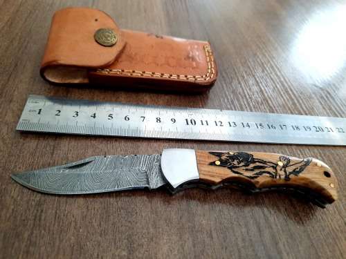 Handmade Damascus steel folding knife with wooden handle scales. Picture engraved. NEW STOCK !