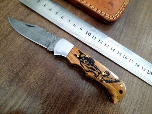 Handmade Damascus steel folding knife with wooden handle scales. Picture engraved. NEW STOCK !
