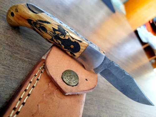 Handmade Damascus steel folding knife with wooden handle scales. Picture engraved. NEW STOCK !