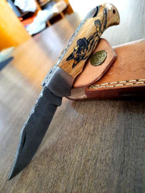 Handmade Damascus steel folding knife with wooden handle scales. Picture engraved. NEW STOCK !