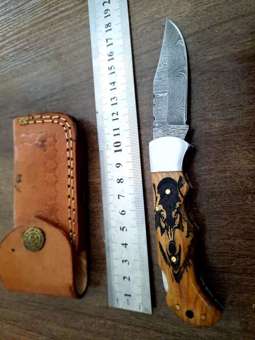 Handmade Damascus steel folding knife with wooden handle scales. Picture engraved. NEW STOCK !