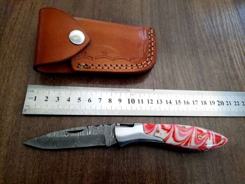 Handmade Damascus steel folding knife with Epoxy Resin handle scales.