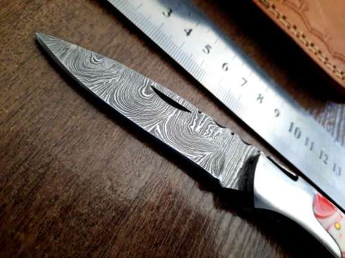 Handmade Damascus steel folding knife with Epoxy Resin handle scales.