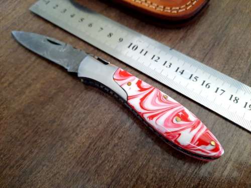 Handmade Damascus steel folding knife with Epoxy Resin handle scales.