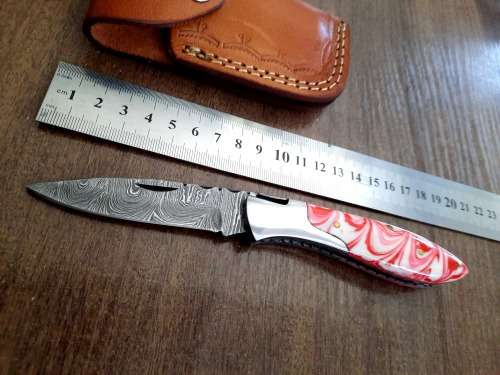Handmade Damascus steel folding knife with Epoxy Resin handle scales.