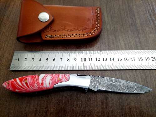 Handmade Damascus steel folding knife with Epoxy Resin handle scales.