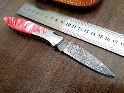 Handmade Damascus steel folding knife with Epoxy Resin handle scales.