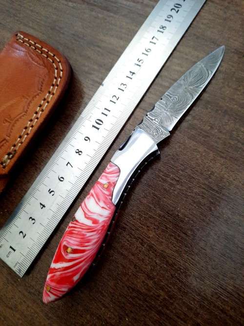 Handmade Damascus steel folding knife with Epoxy Resin handle scales.