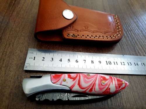 Handmade Damascus steel folding knife with Epoxy Resin handle scales.
