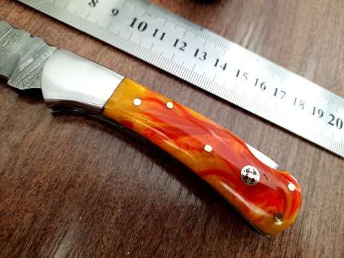 Handmade Damascus steel folding knife with Epoxy Resin handle scales. Crazy R1 start, no reserve.