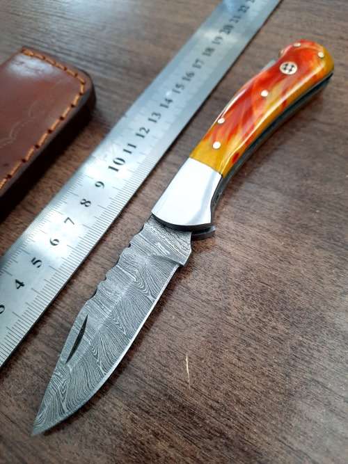 Handmade Damascus steel folding knife with Epoxy Resin handle scales. Crazy R1 start, no reserve.