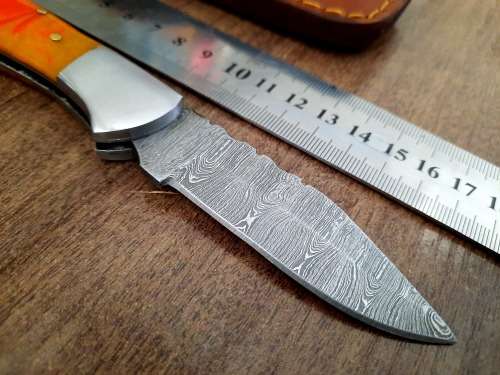 Handmade Damascus steel folding knife with Epoxy Resin handle scales. Crazy R1 start, no reserve.