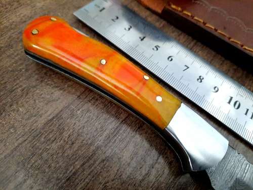 Handmade Damascus steel folding knife with Epoxy Resin handle scales. Crazy R1 start, no reserve.