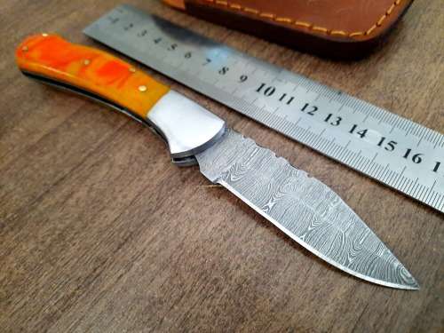 Handmade Damascus steel folding knife with Epoxy Resin handle scales. Crazy R1 start, no reserve.