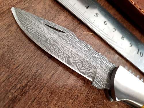 Handmade Damascus steel folding knife with Epoxy Resin handle scales. Leather pouch included.